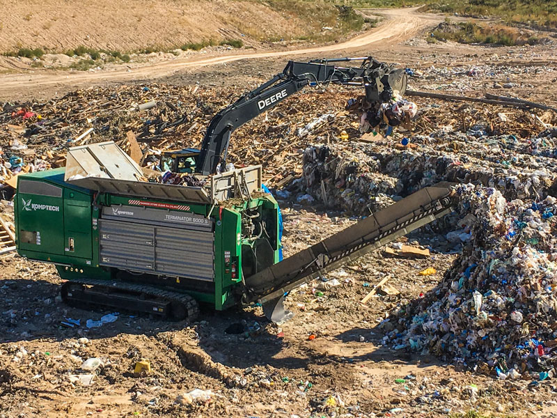 The Komptech Terminator low-speed, single-shaft shredder processing solid waste at a landfill.